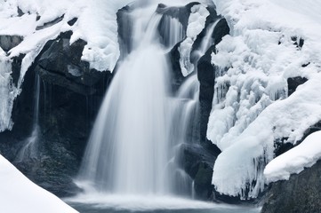 Beautiful mountain waterfall covered in ice