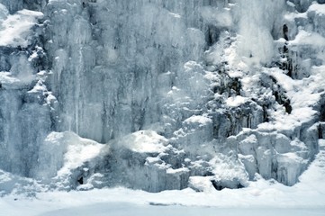 Fototapeta na wymiar Background mountain waterfall among ice and snow