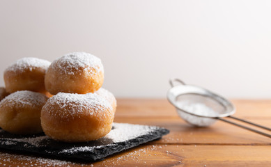 Carnival italian deep fried fritters with sugar icing,Homemade deep fried sweet fritters covered with sugar on a white background