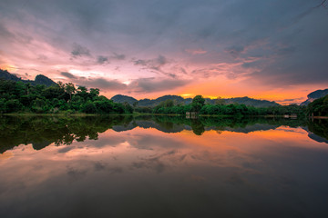 Blurred panoramic nature background on the large lake, reflected by the water of trees, the atmosphere is surrounded by big mountains