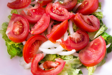 bowl with lettuce and tomato salad, diet and food concept