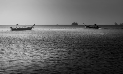 Sea sunrise or sunset with fishing boat in morning light, Black and white and monochrome style