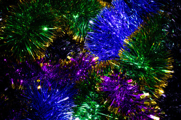 Fototapeta premium Bright multi-colored shiny Christmas garlands for decorating the Christmas tree and home, close-up
