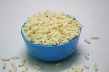 Puffed rice on the blue bowl with white background