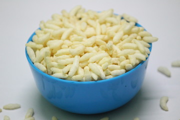 Puffed rice on the blue bowl with white background