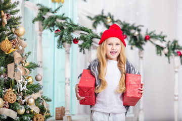 Beautiful happy little cute child girl with smile on her face on background of Christmas interior