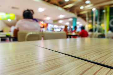 Table in food court at shopping mall blurred