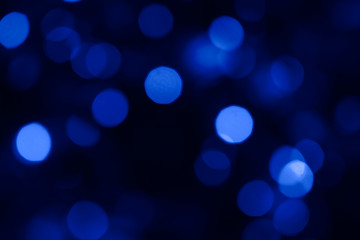 Fototapeta na wymiar Blue monochrome blurred lights bokeh background