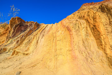 Fototapeta na wymiar Closeup of vivid colors of Ochre Pits a minerals rock formation ochre in West McDonnell Ranges, Northern Territory, Australia, 100 kilometres west of Alice Springs along Larapinta Trail.