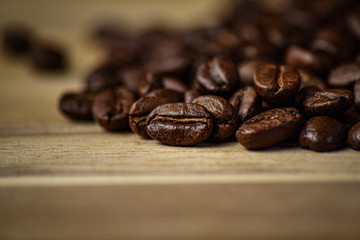 Coffee beans close up on a wooden background