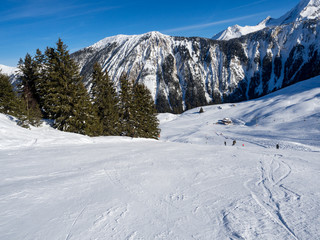Fototapeta na wymiar France, February 2018: Mountains with snow in winter. Meribel Ski Resort, Meribel Village Center (1450 m)
