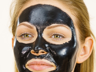 Girl black carbo peel off mask on face