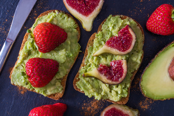 avocado on toast on black background, guacamole