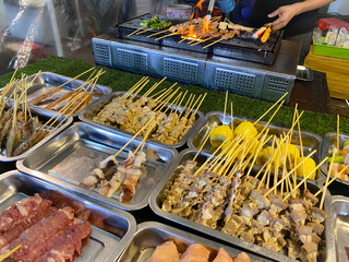 Pork, chicken, meatballs and fish with bamboo sticks. BBQ thai style. Stress food in Thailand.