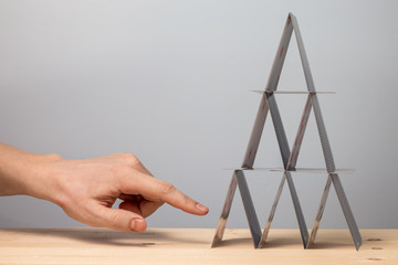 The hand will break the house of cards