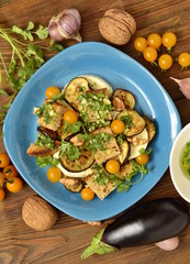 Eggplant with mozzarella, croutons, cilantro pesto and walnuts, vertical, top view