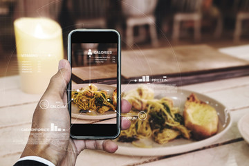 Food Nutrition Scanning Technology, and Healthy eating Lifestyles. a man using mobile smart phone checking nutrition facts of Spaghetti seafood
