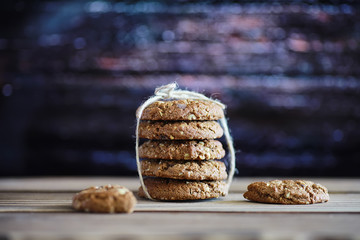 Fresh oatmeal cookies with milk on a texture wood background. Christmas gingerbread cookie and a glass of milk.