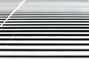 white window blinds on a dark background, parallel lines