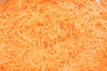 background grated carrots. carrots close-up. finely grated carrots. texture of carrots.