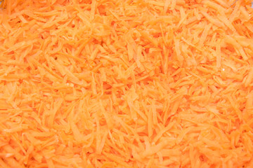 background grated carrots. carrots close-up. finely grated carrots. texture of carrots.