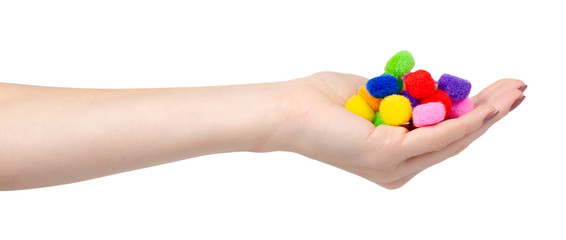 Colored pom pom, party and sewing decoration. Isolated on white.