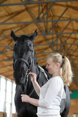 Obraz premium People on a horse training in a wooden arena