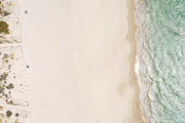 Overhead view of Freemantle beach in Western Australia with tiny unidentifiable figures sunbathing on the sand