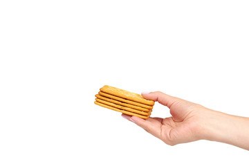 Hand with salty cracker, crispy appetizer, rectangle shape cookie. Isolated