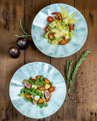Nicoise salad - fried pieces of tuna fillet, cherry tomatoes, mini potatoes, a quail egg, a mix of salad and arugula.