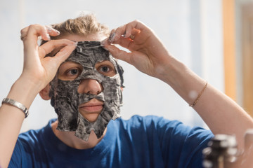 Obraz premium facial cleansing mask. Girl Wearing A Face Mask. lady's beauty. face cleaning at home. facial at home. foamy face mask.