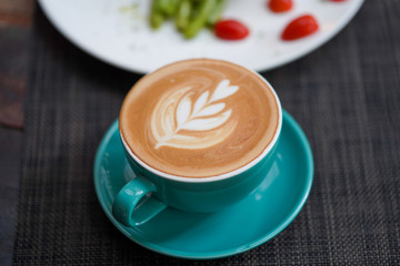 A cup of Coffee Latte on the table.