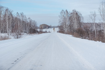Fototapeta na wymiar Winter road. Ride through the winter forest. Snow fell in the forest. Road through the snow.