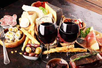 Italian antipasti wine snacks set. Cheese variety, Mediterranean olives, seafood salad, Prosciutto...