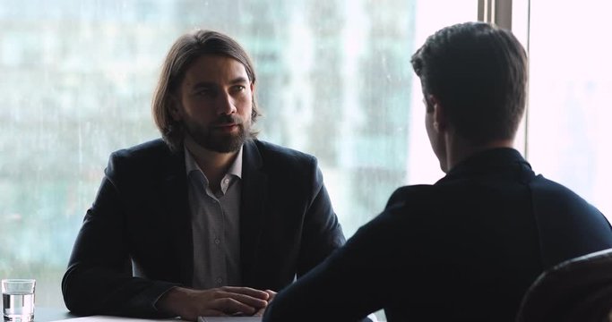 Two businessmen employer and job seeker talking at job interview