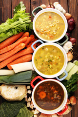 Set of soups from worldwide cuisines, healthy food. Broth with noodles, beef soup and broth with marrow dumplings. All soups with healthy vegetables on table