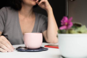 coffee in a pink cup on a background of a girl