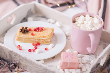 New Year and Christmas holiday mood concept. Cocoa mug with marshmellow and desster on the tray in Frech style