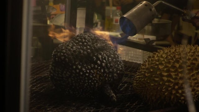 Slowmotion of Thai Durian Fruit being Grilled with Fire