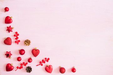 wooden carved Christmas decorations for the holiday tree on a pink background