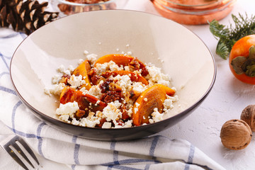Winter dessert. caramelized persimmon with walnuts and cottage cheese