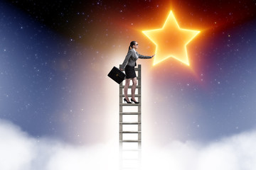 Businesswoman reaching out for stars in success concept