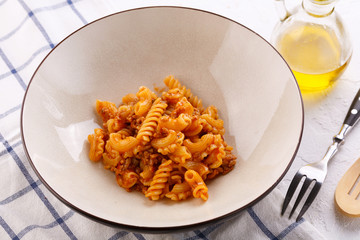traditional pasta with meat and herbs in a beige plate