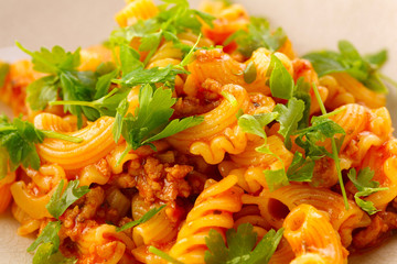 traditional pasta with meat and herbs in a beige plate
