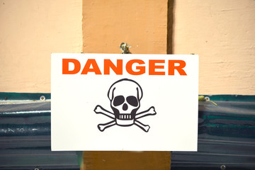 Danger sign with skull symbol.