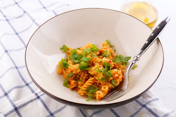 traditional pasta with meat and herbs in a beige plate