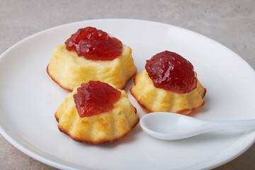 A portion of cottage cheese casserole with strawberry jam and peaches