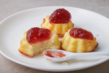 A portion of cottage cheese casserole with strawberry jam and peaches
