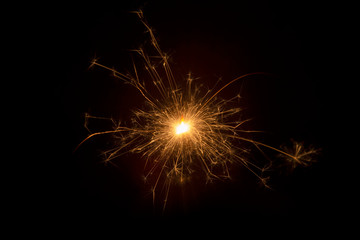 Fototapeta premium Burning sparkler on black background