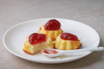 A portion of cottage cheese casserole with strawberry jam and peaches